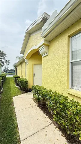 a front view of a house with garden and trees