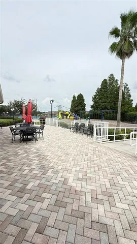 a view of a chair and table in backyard of the house