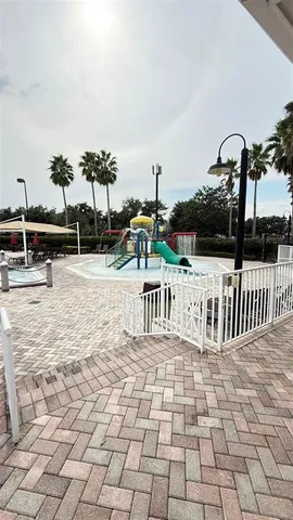 a view of a lake with table and chairs next to a lake