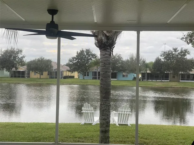 a front view of a house with a yard and potted plants