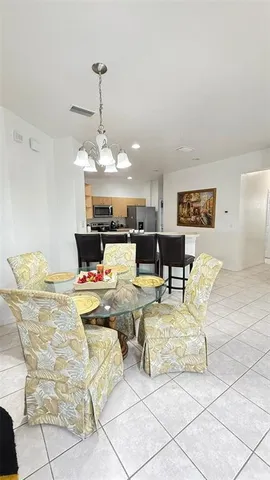 a living room with fireplace furniture and a chandelier