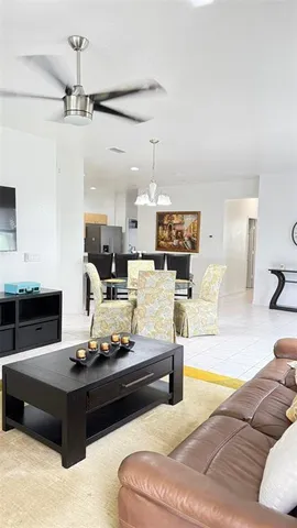 a living room with furniture and a chandelier