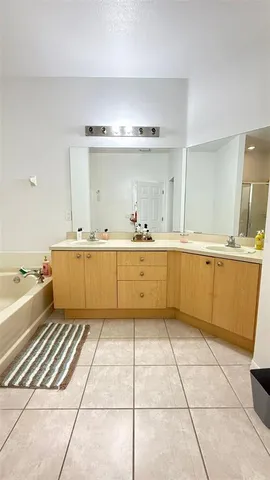 a large kitchen with a stove a sink and cabinets