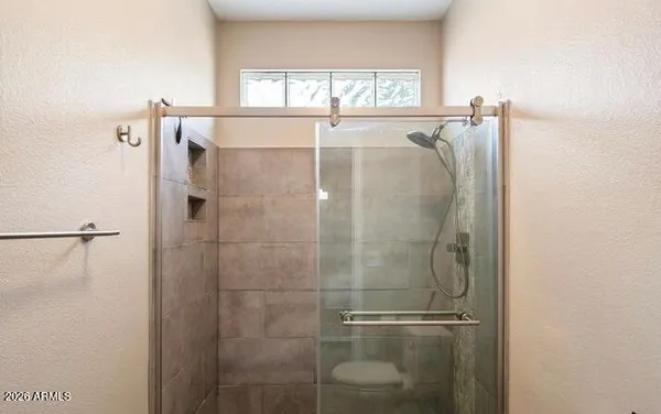 a bathroom with a shower and a sink
