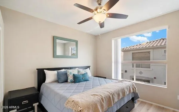 a bedroom with a large bed and a window