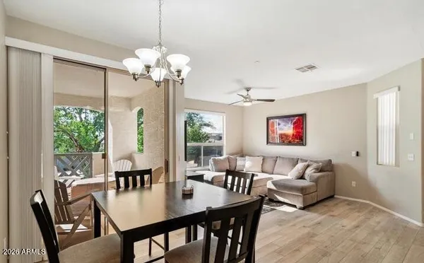 a view of a livingroom and dining room with furniture wooden floor and a chandelier