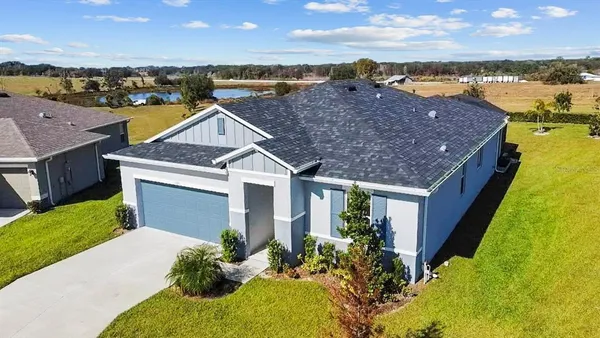 a aerial view of a house with a yard
