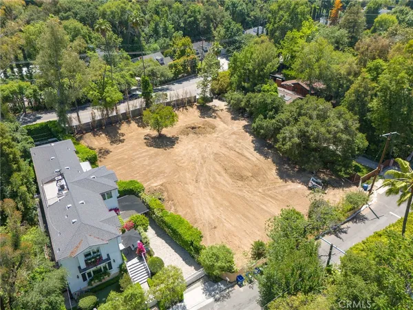 an aerial view of a house with yard