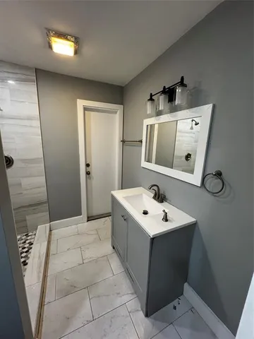 a bathroom with a sink a toilet and mirror