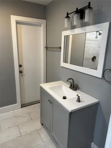 a bathroom with a sink and shower