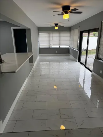 a large kitchen with a large counter top stainless steel appliances and cabinets