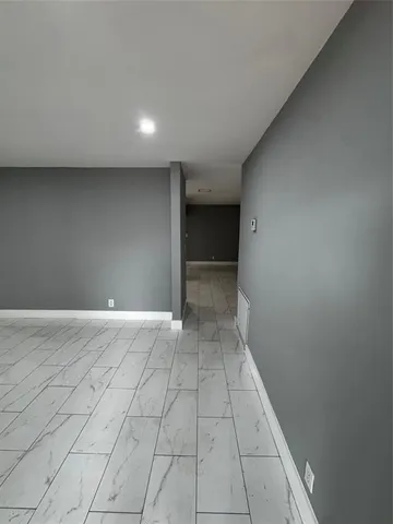 a large kitchen with kitchen island granite countertop a sink and a stove top oven