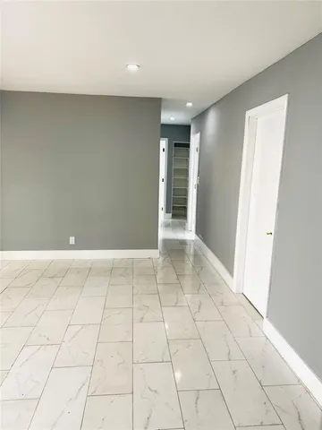 a large white kitchen with a stove a sink dishwasher and a refrigerator