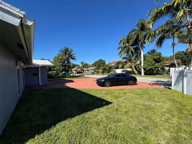 a view of back yard of the house and swimming pool