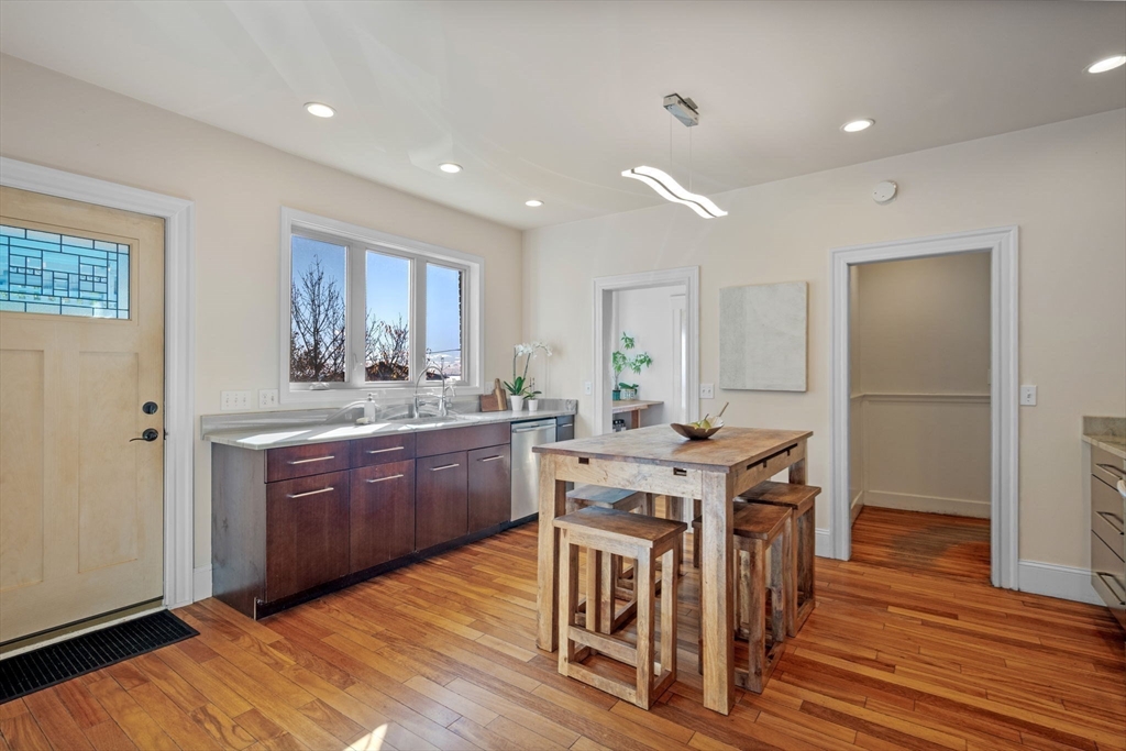 21 Bay View Drive Swampscott, MA 01907 - Photo 20 of 42 a kitchen with stainless steel appliances granite countertop a kitchen island hardwood floor sink stove dining table and chairs