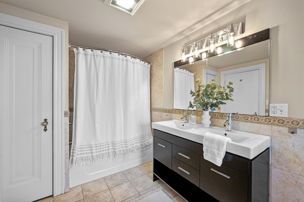 21 Bay View Drive Swampscott, MA 01907 - Photo 34 of 42 a bathroom with a sink double vanity and a mirror