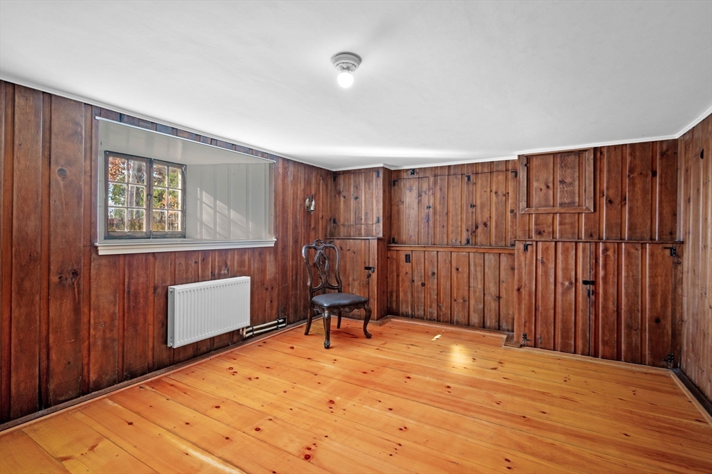 21 Bay View Drive Swampscott, MA 01907 - Photo 40 of 42 a bedroom with a bed and a chair