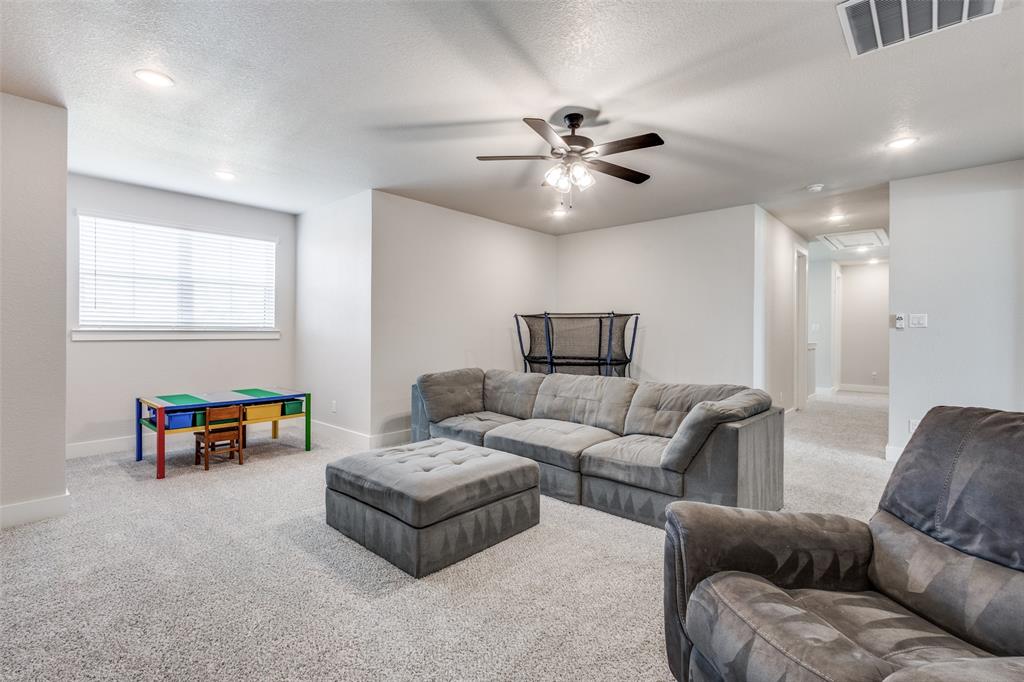 2255 County Road 377 Van Alstyne, TX 75495 - Photo 26 of 35 a living room with furniture and a chandelier