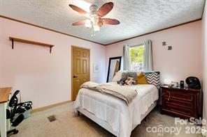 179 Fresh Water Rdg Road Whittier, NC 28789 - Photo 28 of 48 a bedroom with a bed and a chandelier