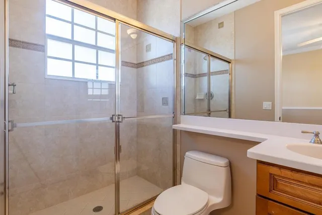 a bathroom with a sink a toilet and a mirror