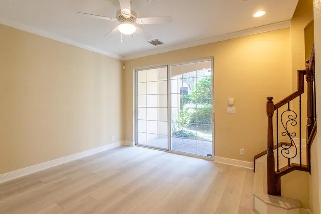 a view of swimming pool with a garden and palm trees
