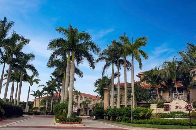a view of multi story residential apartment building with a yard