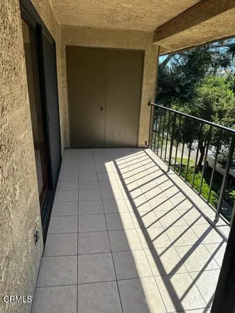 a balcony with a bed