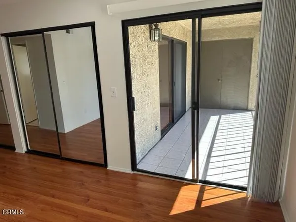 an entryway with wooden floor and stairs