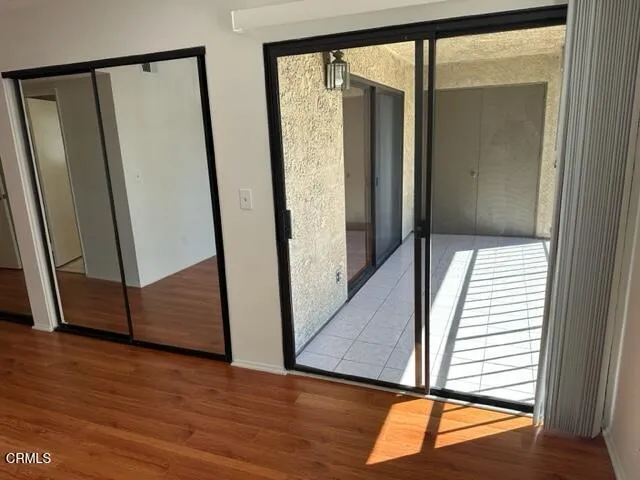 an entryway with wooden floor and stairs