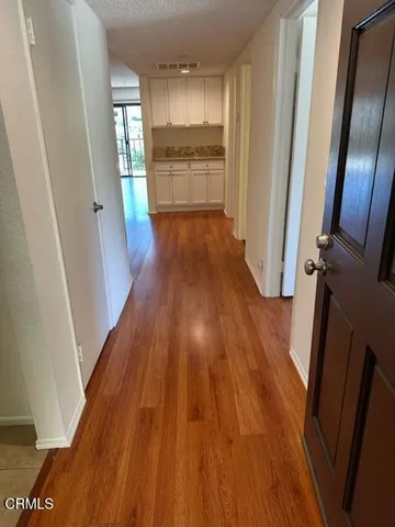 a view of a kitchen from a hallway