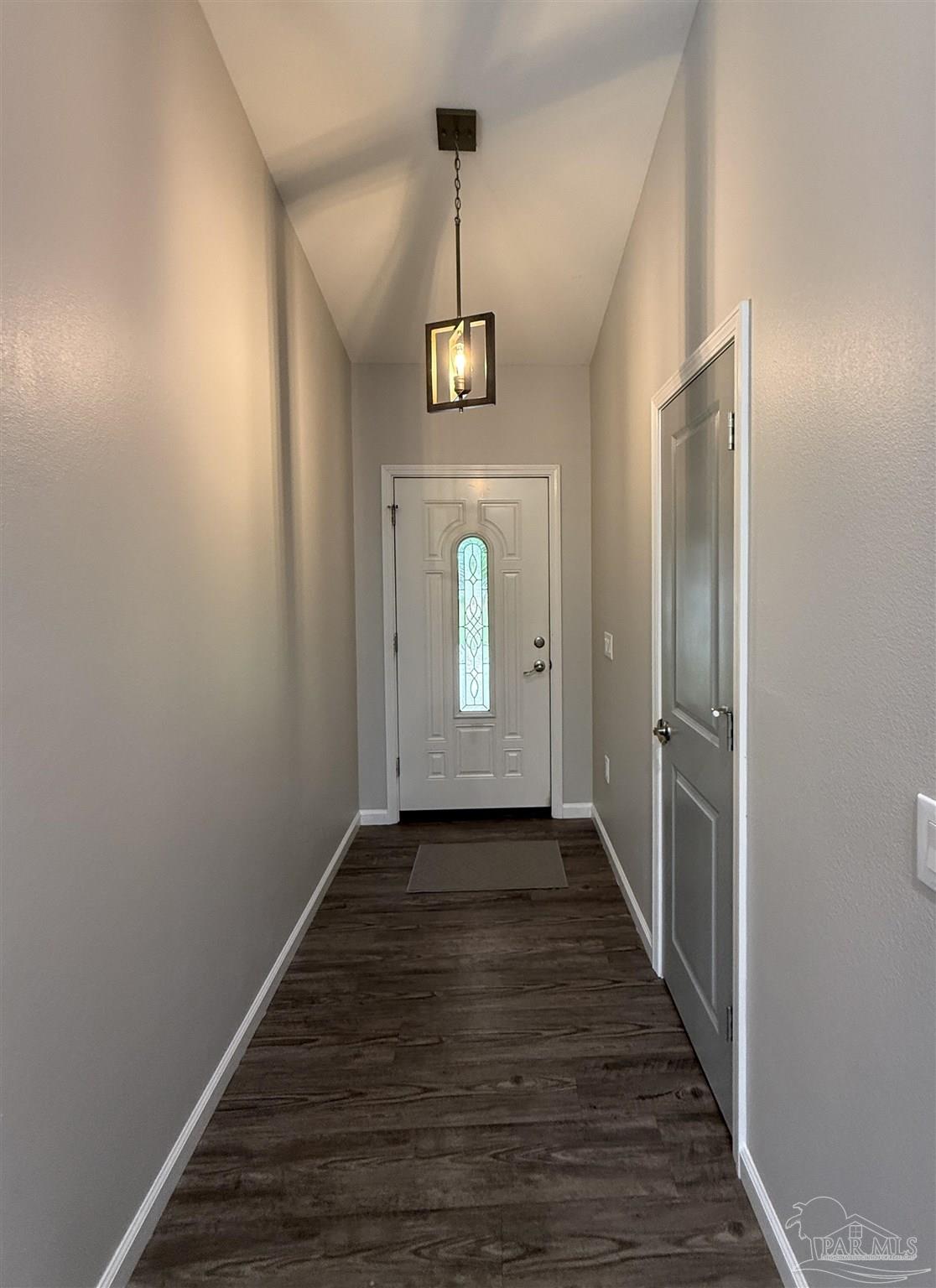 5553 Riviera Drive Milton, FL 32583 - Photo 13 of 23 a view of a hallway with wooden floor and staircase