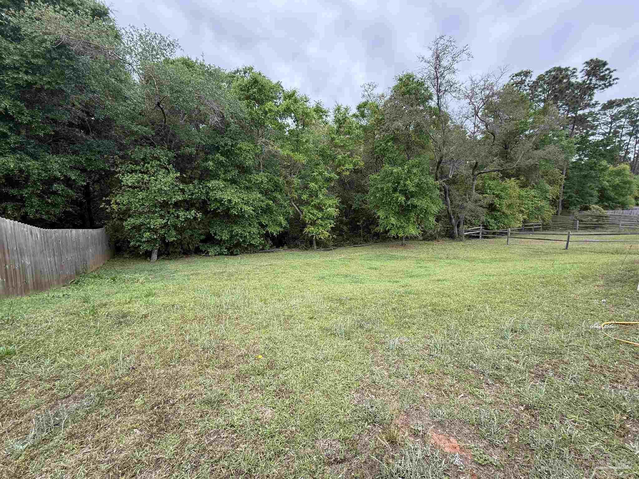 5553 Riviera Drive Milton, FL 32583 - Photo 19 of 23 a view of outdoor space with deck and yard