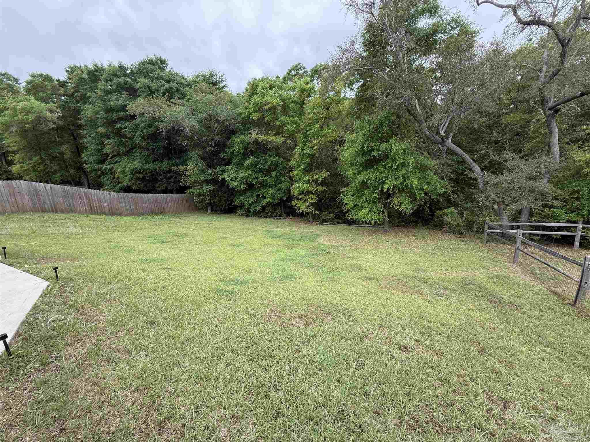 5553 Riviera Drive Milton, FL 32583 - Photo 20 of 23 a view of a field with plants in front of it