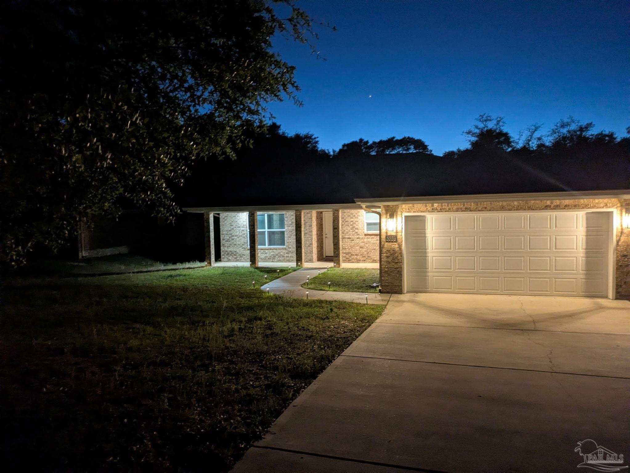 5553 Riviera Drive Milton, FL 32583 - Photo 23 of 23 a front view of a house with a yard