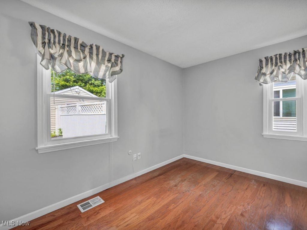 5038 Forest Road Mentor, OH 44060 - Photo 18 of 29 Empty room with hardwood / wood-style floors and a healthy amount of sunlight