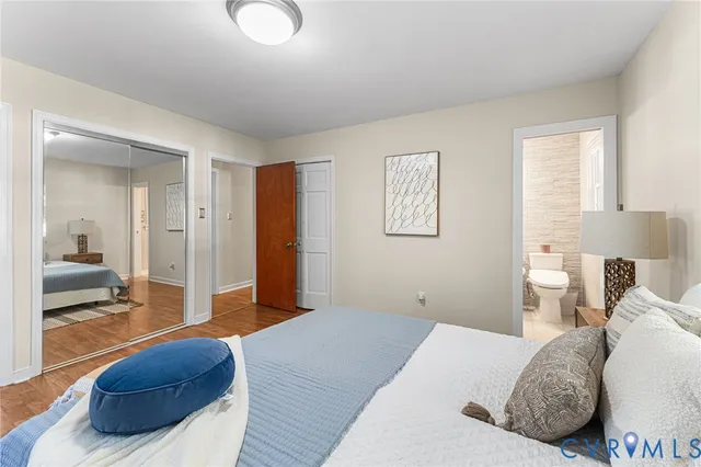 a bedroom with a large bed and a couch