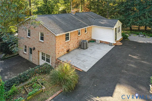 a aerial view of a house with a yard and large tree