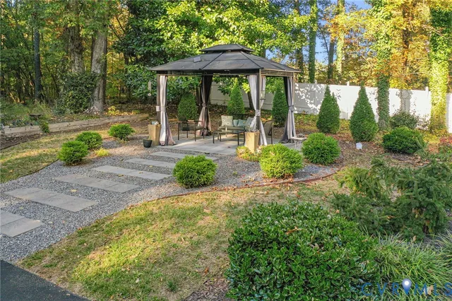 a view of a patio with table and chairs under an umbrella