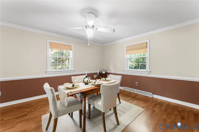 a view of a dining room with furniture a chandelier and wooden floor