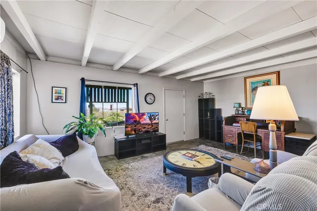 a view of a patio with table and chairs with wooden floor and fence