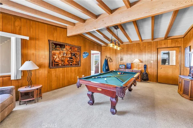 a living room with furniture and kitchen area