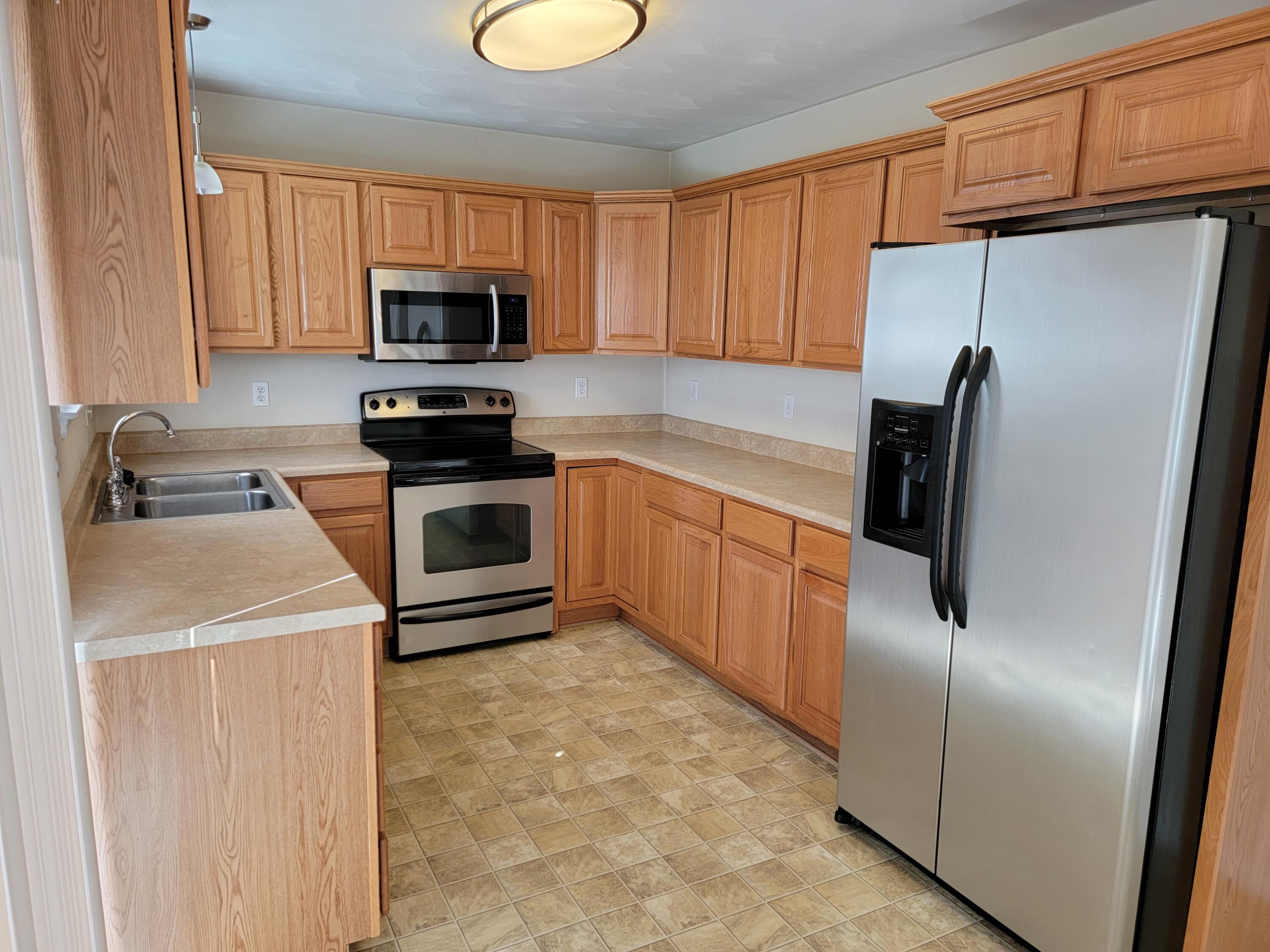 3305 Troxell Road Southeast Roanoke, VA 24014 - Photo 4 of 14 a kitchen with stainless steel appliances granite countertop a refrigerator stove top oven a sink and dishwasher