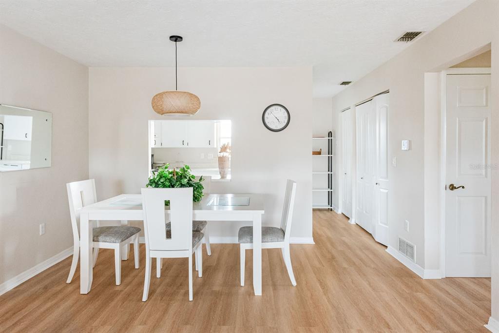 1531 Placida Road, Unit 1204 Englewood, FL 34223 - Photo 11 of 58 a view of a dining room with furniture window and wooden floor
