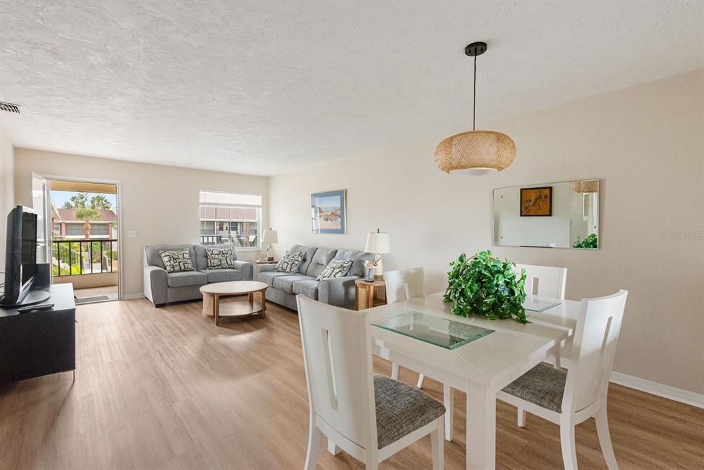1531 Placida Road, Unit 1204 Englewood, FL 34223 - Photo 13 of 58 a view of a dining room with furniture window and wooden floor