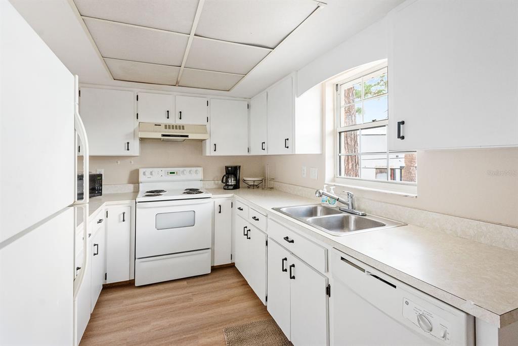 1531 Placida Road, Unit 1204 Englewood, FL 34223 - Photo 15 of 58 a kitchen with cabinets appliances a sink and a window