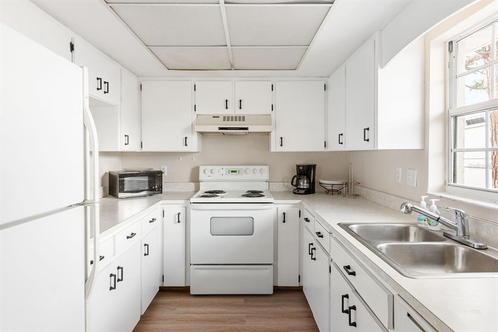 1531 Placida Road, Unit 1204 Englewood, FL 34223 - Photo 16 of 58 a kitchen with cabinets appliances a sink and a window