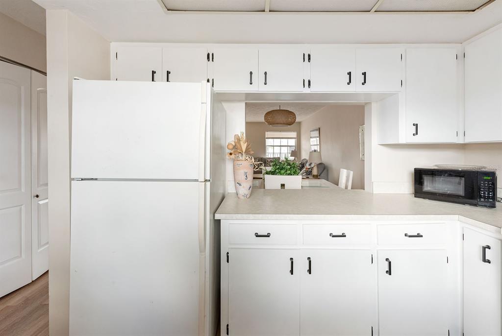 1531 Placida Road, Unit 1204 Englewood, FL 34223 - Photo 18 of 58 a view of kitchen with cabinets and refrigerator