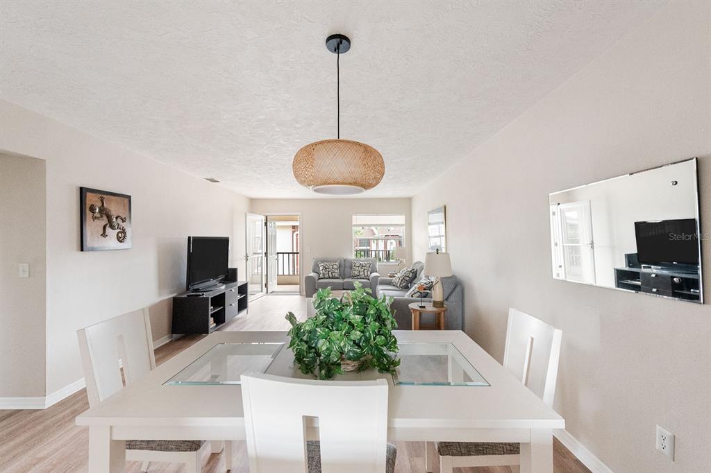 1531 Placida Road, Unit 1204 Englewood, FL 34223 - Photo 21 of 58 a living room with furniture a flat screen tv and a large window
