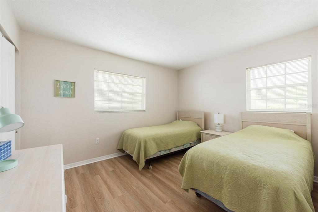 1531 Placida Road, Unit 1204 Englewood, FL 34223 - Photo 32 of 58 a bedroom with two beds and a window