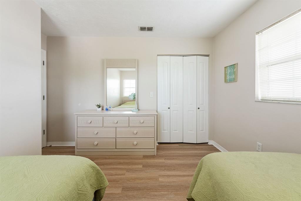 1531 Placida Road, Unit 1204 Englewood, FL 34223 - Photo 34 of 58 a bedroom with a bed and a dresser